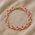 Anmutiges Wellenarmband mit rosa Stein